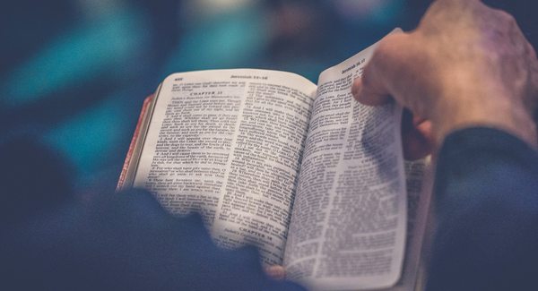 An open Bible in warm light, for the Sunday message from Isaiah 59:15&ndash;21.